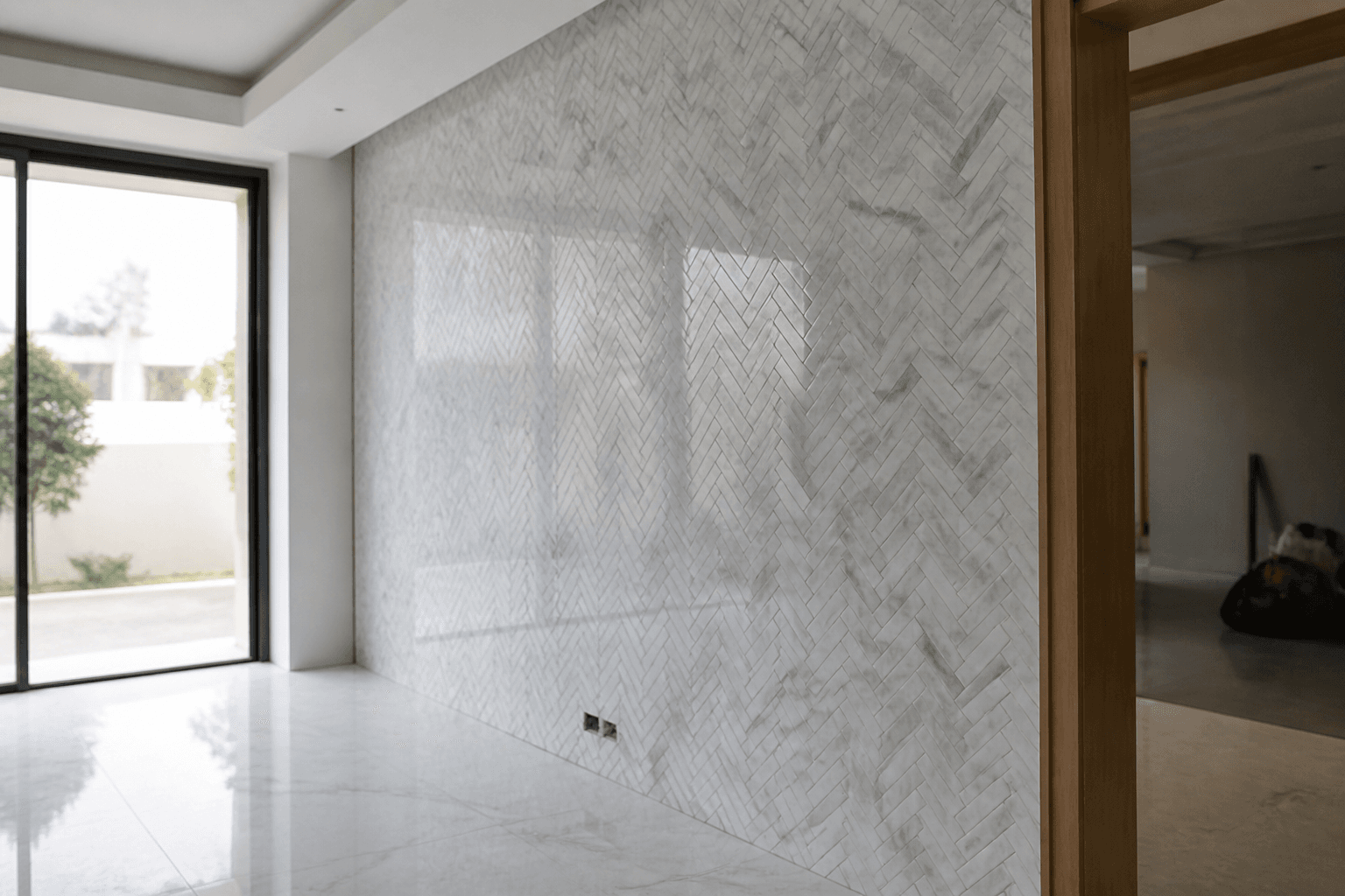 Herringbone marble mosaic feature wall in a villa dining room